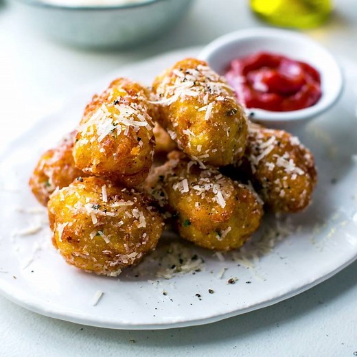 10K views · 238 reactions | New Recipe Video: Truffle Oil & Parmesan Tater Tots! Are Tater Tots a thing anywhere outside of the US? They're like a potato croquette but these ones are homemade and drizzled with truffle oil and a generous scattering of Parmesan cheese! A grown up version of a childhood snack! | Donal Skehan | Facebook