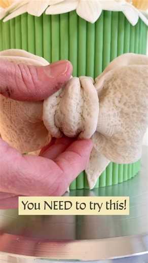 🎀🌼 Create a Fondant Daffodil Cake Tied with a Bow 🌼 🎀 Head to our blog to see how to create this stunning daffodil bouquet cake by @Bibbidi Bake Co, beautifully finished with a lace-textured fondant bow. . . . . #cakedecorating #springcake #eastercake #cakeidea #siliconemolds