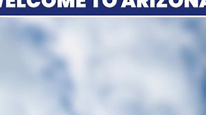 A sign reading Welcome to Arizona, with a landscape in the background