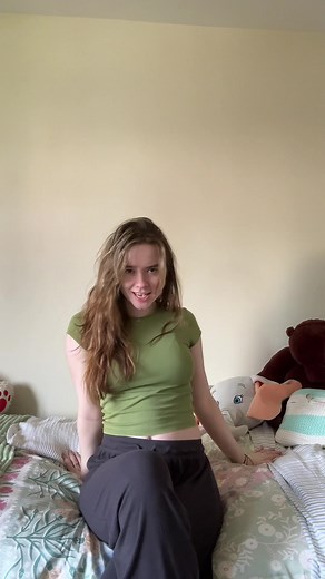 Young Woman Posing in a Bright Bedroom Setting