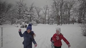 children sledding in winter in the park