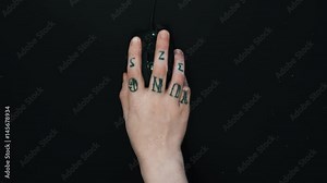 Female right hand with colorful tattoos shaky clicking computer mouse on black table, playing video game point of view close up