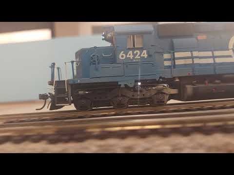 Ho scale conrail train passes amtrak 100 and ns local