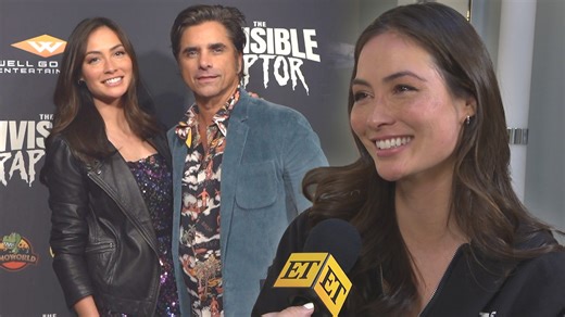 John Stamos’ wife, Caitlin McHugh, reacts to a sweet message from him and dishes all about her new film, ‘The Invisible Raptor,’ in theaters on Dec. 6. | Entertainment Tonight