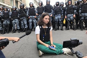 Teenage girl reading constitution in front of Putin's riot police becomes symbol of Russian resistance