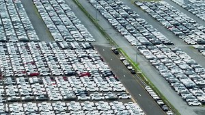 A drone flying over a lot of cars parked in an automotive factory would provide an impressive and unique perspective of the manufacturing process. Logistics supplies automotive industry. 4K