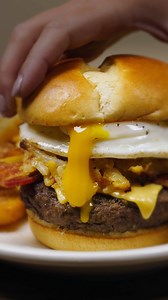 Is your mouth waterin’ yet? The Breakfast Burger will do that. A half-pound beef patty, melty American cheese, a big ol’ scoop of our signature Hashbrown Casserole, sizzled bacon and a silky sunny side egg. | Cracker Barrel Old Country Store