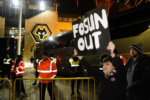 Wolves fans protest during Premier League match against Manchester United