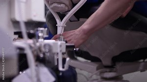Closeup of dentist adjusting nitrous oxide tubes on dental patient