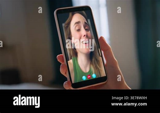 Happy girlfriends talk video conference on mobile phone indoors. Hand holding cell. Unrecognized woman smiling chatting online with friend by web camera. Positive colleagues calling videoconference Stock Video Footage - Alamy