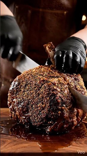This video captures the expert carving of a succulent, bone-in prime rib roast: