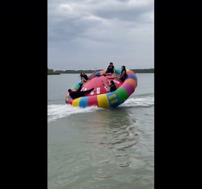 Inflatable UFO ride throws riders into river
