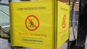 Closed escalator for maintenance. Sign with the inscription that the escalator is not working and is under repair. Shopping center, repair equipment