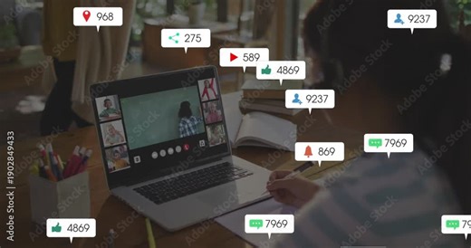 Child girl taking notes for class, incoming social bubbles appearing and obscuring laptop screen