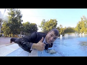 Photo session trash the dress in pool. In tuxedo.