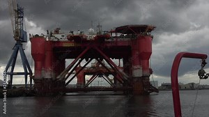 Sailing through Belfast Docks home of the Titanic with two of the Dolphin Oil Rigs in for repairs.