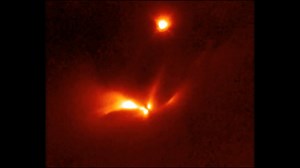 • Strobe-like Flashes in a Suspected Binary Protostar • This video shows a pulse of light emanating over a 25.34-day period. from the protostellar object LRLL 54361. Most if not all of this light results from scattering off circumstellar dust in the protostellar envelope. An apparent edge-on disk, visible at the center of the object and three separate structures are interpreted as outflow cavities. This is caused by the propagation of the light pulse through the nebula. Astronomers propose that 