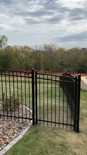 Ornamental steel with bottom mesh to keep dogs in.