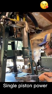 Worker operates a single-piston power hammer, driving repeated downward blows to shape and forge metal precisely. #PowerHammer #Metalwork #Forging #IndustrialTools #Hammering #MetalShaping #WorkshopLife | Kayala Domes
