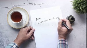 man hand writing a letter with fountain pen