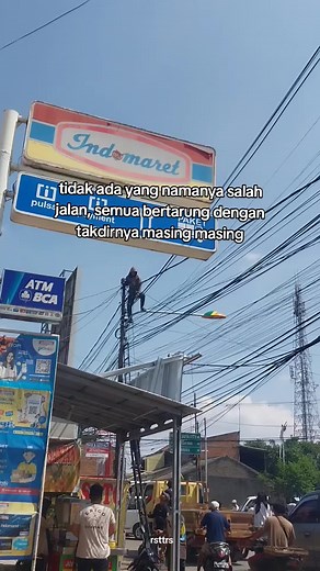Urban Utility Pole Climbing in Busy Street Scene