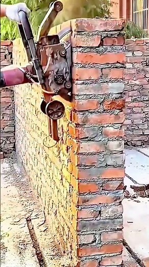 Spraying cement mortar evenly on brick wall surface using a high pressure plastering machine