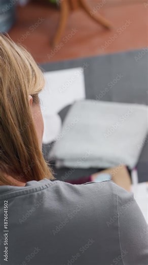 Designers craft textiles, Interior designer focusing on pattern layout and material selection, Fashion studio professional systematically arranges fabric pieces for creative collection development