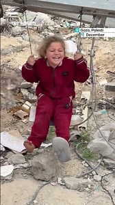 Palestinian children play among ruins left by Israeli attacks