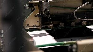 Factory for the production of cardboard boxes. Automatic Folding and gluing line. Cardboard boxes on conveyor belt. Folding boxes close-up.