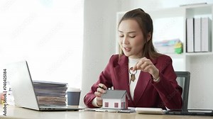 Asian female sales representatives offer prices and conditions for buying or renting real estate, recommending houses to clients. Explain home interior decoration, online home sales consultant
