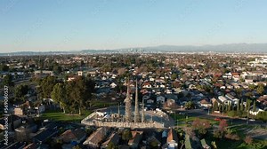 Wide push-in aerial shot of the Watts Towers in Los Angeles, California. 4K