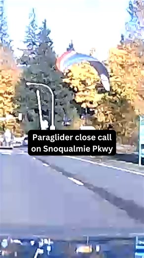 CLOSE CALL: A paraglider came within feet of the roadway at the Snoqualmie Parkway and SR 202 on Sunday afternoon. Aaron Yates captured the moment on his dash cam and says the paraglider took off from a parking lot and immediately turned toward the road, coming within feet of traffic. After flying over the road, the glider safely made it over to Snoqualmie Falls, Yates says. #news #snoqualmie #kiro7 #paraglider | KIRO 7 News