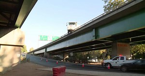 Street sweeper hangs off the side of Highway 50 in Sacramento