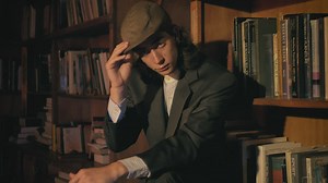 Young old fashion model smoking in a bookstore - Free Stock Video