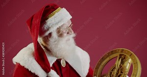Santa pointing at vintage clock showing five minutes to midnight. 4K.