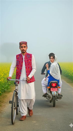 Gemini ♊ PROMPT 👇 @Tanhaabbasi51 :Create a cinematic, ultra-realistic 9:16 portrait of me. I am wearing a white shalwar kameez, a Sindhi topi on my head, and an Ajrak waistcoat. I have my own bicycle, and I am sitting on a stone, fixing the chain of the bicycle. On both sides of the road, blooming mustard flowers can be seen. The background shows thick fog, like smoke, typical of a cold January morning. A motorcycle is going away in the background. A boy is riding it, and a girl is sitting behi