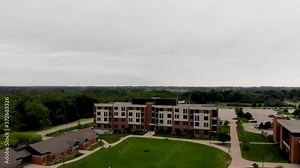 Aerial drone view of university grounds with school buildings, residence halls and central grass yard in the middle of University of Wisconsin - Parkside.