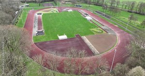 Sports field, runners track. Aerial drone view. Athletics running track. Racetrack exercise training ground. Aerial drone view.