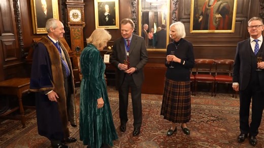 Queen Camilla visited Vintners’ Hall, one of London’s oldest Livery Companies, where she attended a special reception as a Liveryman of The Vintners’ Company. The Company, historically linked to the wine trade, now supports charitable and educational work. Inside, Her Majesty was shown a rare copy of A Book of Wine, written by her grandfather, P. Morton Shand, whose work helped shape Britain’s appreciation of food, wine and culture. Voice by AI. | The Royal Family Channel