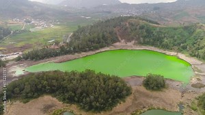 volcanic sulfur lake telaga warna in dieng plateau, java Indonesia. mountain tropical landscape lake with green water among mountains. this lake is one mainstay tourist destinations in Wonosobo