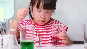 Children are learning and doing science experiments in the classroom. Two little sisters playing science experiment for home schooling. Easy and fun science experiments for kids at home.