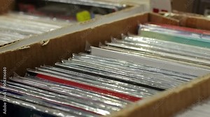 Comic books are kept in protective sleeves inside a cardboard box for preservation and protection