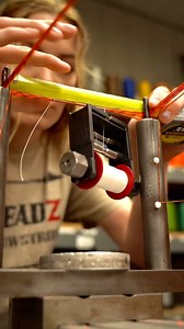 Serving an eye on a speckled flo. orange & black custom bowstring. #ThreadZ employee, Arieal, is fast as lighting when it comes to serving eyes! This video shows why we have extremely fast turnaround times. Our employees are quick, efficient, but also very keen to detail and quality! #bowstrings #threadzcustombowstrings #archery #hunting #work #create | ThreadZ Custom Bowstrings