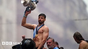 Manchester City fans and players celebrate historic Treble in the rain