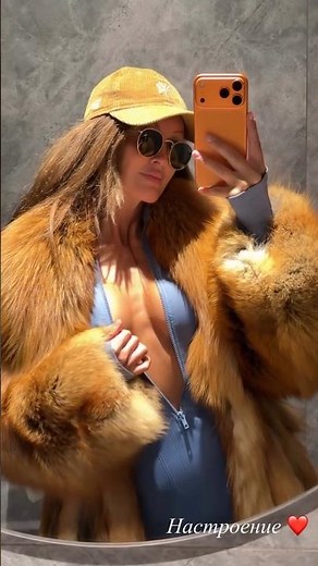 Pretty girl showing off new red fox fur coat and going out with it