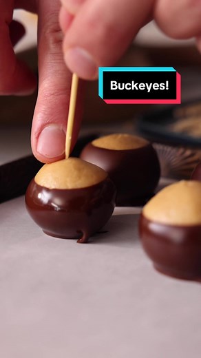 These Easy Buckeyes are a chocolate peanut butter dream come true. Salty sweet balls of peanut butter dipped in chocolate come together with just a few ingredients and no baking but are so delicious and yes, they look just like buckeye nuts! Recipe up on the blog #preppykitchen #baker #recipevideo #foryou #chocolate