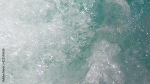 Slow motion shot of air bubbles coming out to the surface of a jacuzzi pool water