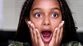 Excited child shocking reaction. girl reacts with surprise with open...