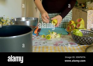 Pears being prepped for preserves, Efficiently preparing pears for preserves in lively kitchen environment