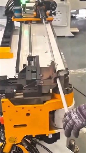 A machine bending metal rod into precise angular shape